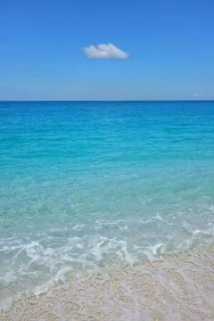 Minimalist clear waters and a cloud in Greece Stock Photos
