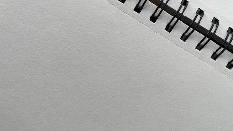 Minimalist close-up of an open spiral notebook with clean, white pages-perf.. Foto stock