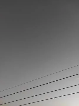 A minimalist composition features a gradient sky with four parallel black lines. Stock Photos