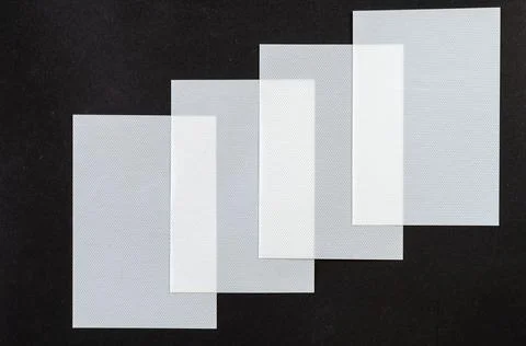 Minimalist composition with white plastic sheets. Rectangular textured sheets Stock Photos