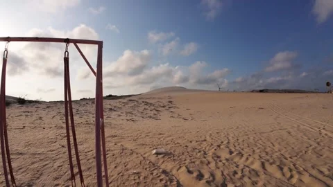 Minimalist Desert View of Empty Wooden Swing on Bau Trang Sand Dunes Stock Footage 340964313