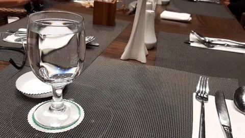 Minimalist Dinner Table Layout With Wineglass Water Ceramic Utensils On Wooden Stock Footage 317944206