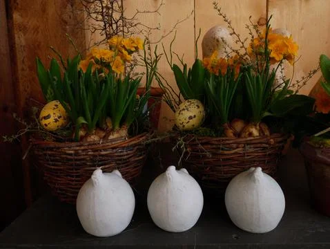 Minimalist Easter tabletop decor with three white ceramic bunnies and bloom.. Foto stock