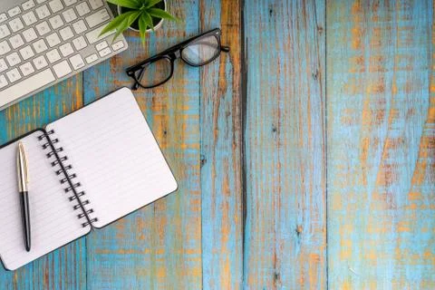 Minimalist flat lay composition of book, fountain pen, plant and glasses Stock Photos