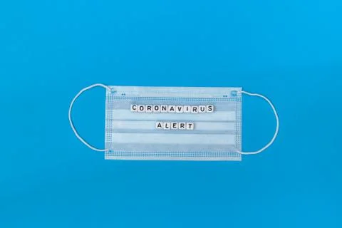 Minimalist flat lay composition with white medical mask and coronavirus alert Photos