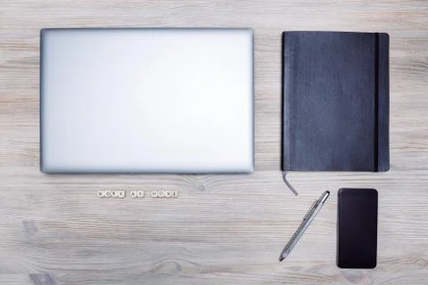 Minimalist flat lay of computer phone and notebook Stock Photos