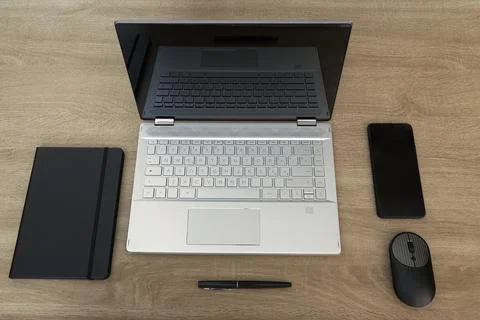 Minimalist flat lay of a modern work desk with laptop and smartphone Stock Photos