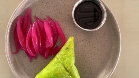 A minimalist food presentation featuring a green triangular Lupis. Stock Footage 333835992