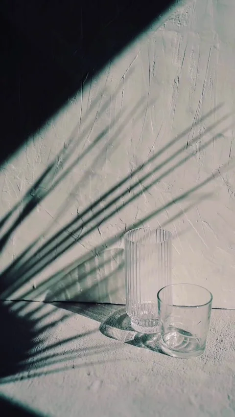 Minimalist Glasses and Shadows on Bright Surface Video stock 342780722