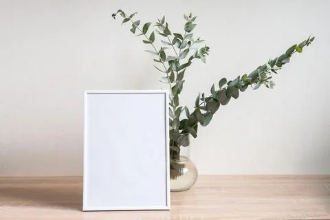Minimalist home decor with empty frame mock-up on white wall background Stock Photos