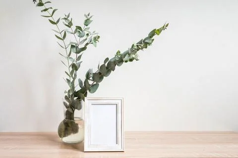 Minimalist home decor with empty frame mock-up on white wall background Stock Photos