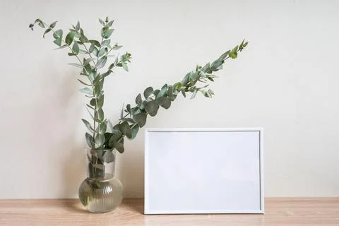 Minimalist home decor with empty frame mock-up on white wall background Stock Photos