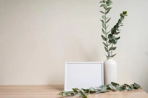 Minimalist home decor with empty frame mock-up on white wall background Stock Photos