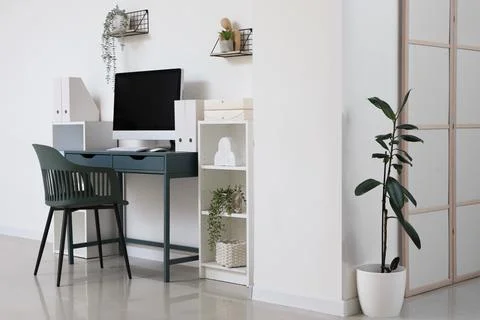 Minimalist home office workspace with computer and plants Stock Photos