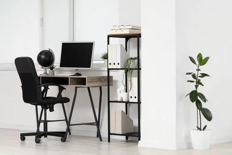 Minimalist home office workspace with computer and plants Stock Photos