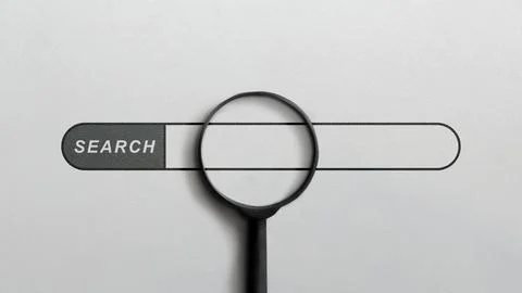 A minimalist image featuring a black magnifying glass placed over an empty .. Stock Photos