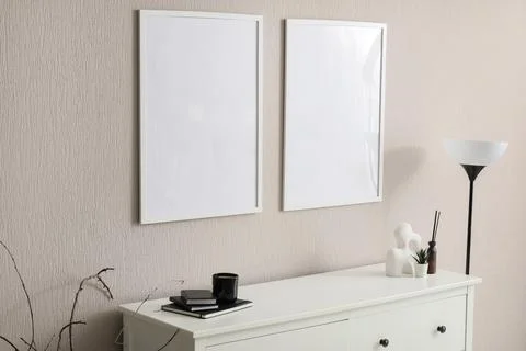 Minimalist interior with blank frames and decorative objects Stock Photos