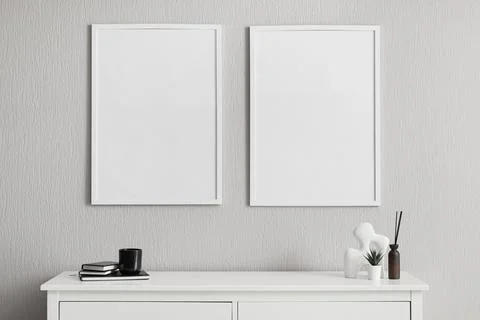 Minimalist interior with blank frames and decorative objects Stock Photos