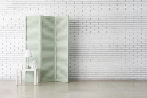 Minimalist interior with folding screen and side table Stock Photos