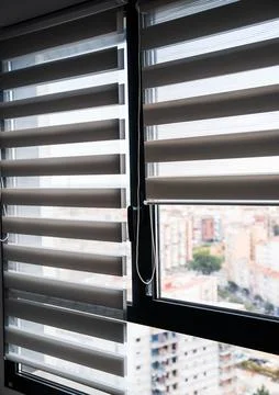 Minimalist interior window with zebra roller blinds and chain mechanism Foto stock