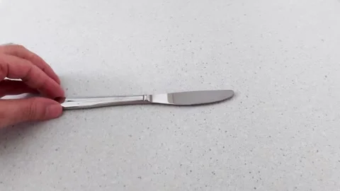 Minimalist Kitchen Action: Knife Placement on Clean Surface Stock Footage 318641096