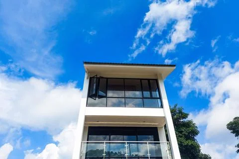 Minimalist luxury multi-storey house with a sky and cloud backdrop Stock Photos