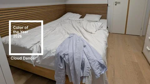 Minimalist messy bed in cloud dancer color of the year 2026 interior Stock Photos