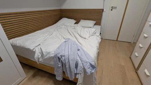Minimalist messy bed in cloud dancer color of the year 2026 interior Stock Photos