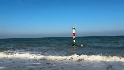 Minimalist Ocean Waves with Navigation Pole and Day Moon 4K Stock Footage 331897384