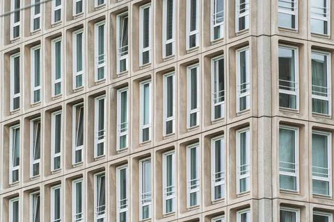 Minimalist office facade with repeating window pattern and clean architectura Stock Photos