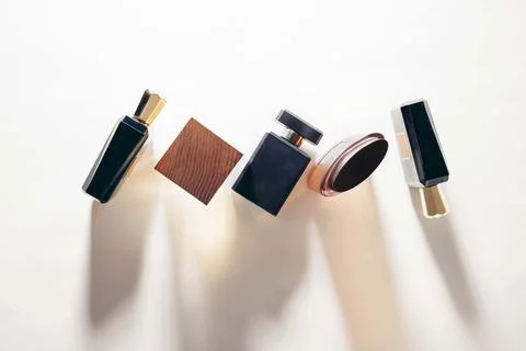 Minimalist perfume bottle composition casting soft shadows on white background Stock Photos