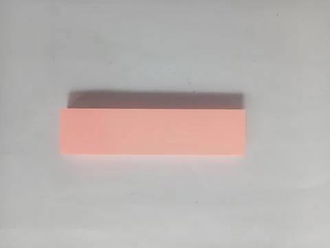 Minimalist pink rectangular sticky note on a white background Stock Photos