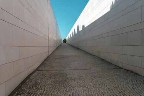 Minimalist ramp between high limestone walls leading toward Sanctuary of Fa.. Stock Photos