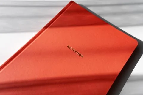 Minimalist Red Notebook with Shadows on White Background for Study or Offic.. Foto stock