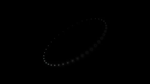Minimalist ring of glowing light particles against a deep black background Video stock 335117460