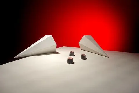Minimalist setup with two white prisms and chocolate candies on red backdrop Stock Photos