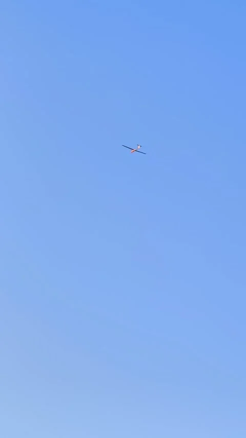 Minimalist shot of a small glider on a clear blue sky . Stock Footage 337483294