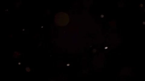 Minimalist sparse dust particles float through a dark void Stock Footage 329598595