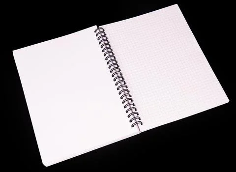 Minimalist spiral notebook with graph paper, positioned diagonally against bl Stock Photos