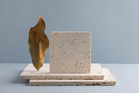 Minimalist Stone and Leaf Composition on Blue Background for Modern Design Stock Photos