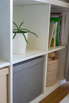 Minimalist storage system with fabric boxes and natural decor in calm home Stock Photos
