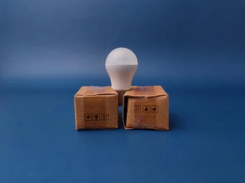 A minimalist studio shot featuring a small white USB LED light bulb balance.. 库存照片