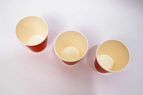 Minimalist Studio Shot: Three Empty Red and Cream Paper Cups on White Backg.. Stock Photos