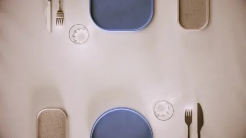 Minimalist table setting with plates and cutlery on bright surface view. 스톡 동영상 344710974
