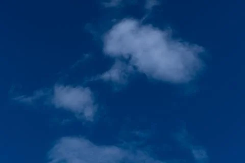 Minimalist Thin White Clouds on Deep Blue Sky Background Stock Photos