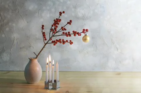 Minimalist third advent with four small candles, three are burning and a berry 写真素材