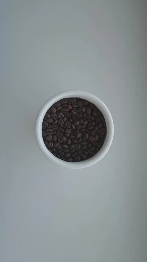 Minimalist top down view of a hand opening and closing a white canister filled Stockbeeldmateriaal 347457924