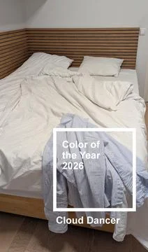 Minimalist unmade bed in cloud dancer color of the year 2026 interior vertica Stock Photos