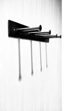Minimalist Wall Hooks Casting Shadows in Monochrome Foto stock
