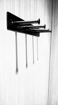 Minimalist Wall Hooks Casting Shadows in Monochrome Stock Photos